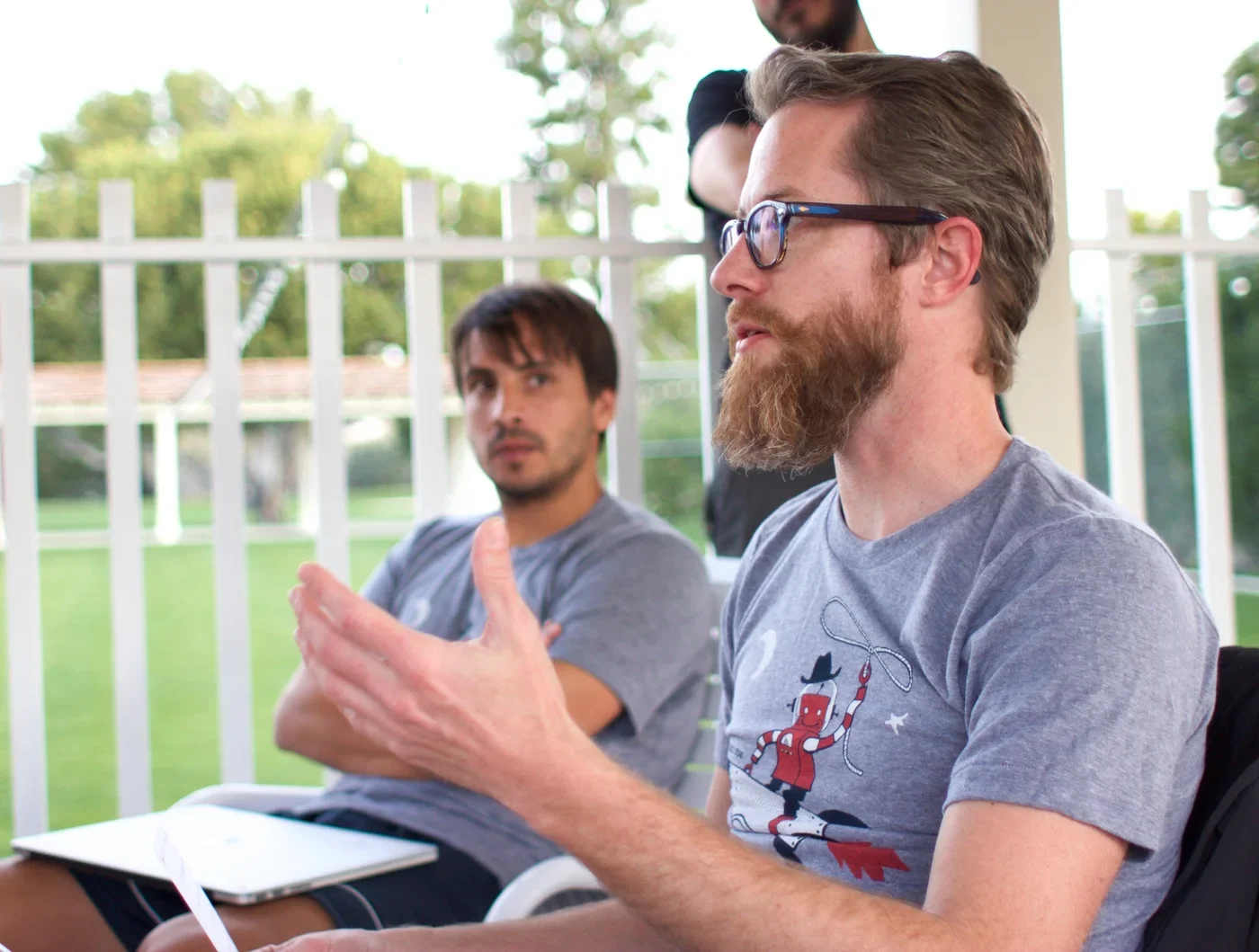 Two Lullabot team members engaged in group conversation.