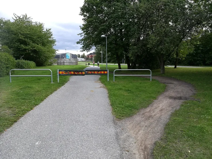 Path through grass going around barrier