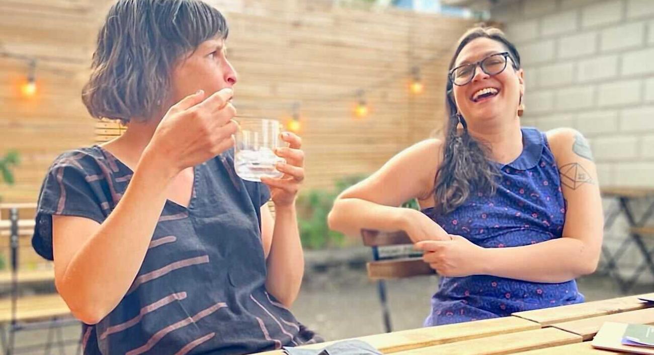 Two Lullabot team members sitting at an outdoor cafe.