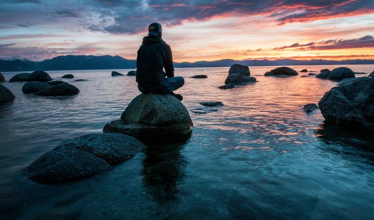 sitting on rock in thought