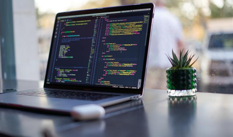 Laptop on table with code IDE open