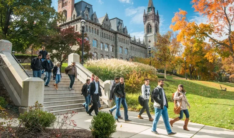 Campus of Lehigh University with students walking down stone steps.