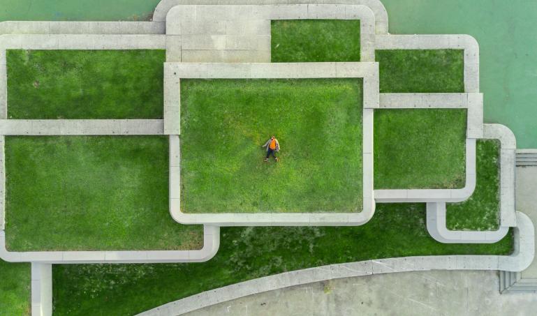 Stacked levels of grass, surrounded by concrete borders