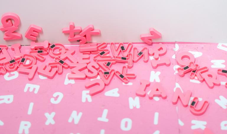 A photo of magnetic letters scattered on a table