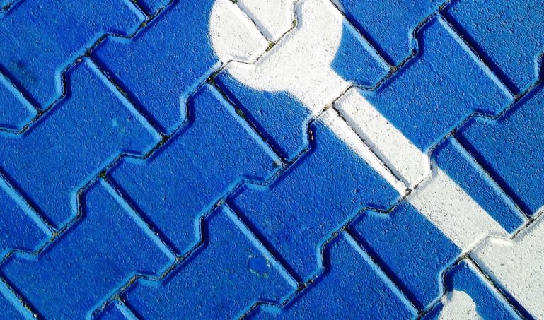 Blue bricks with International Symbol of Access painted in white
