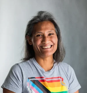 Nikki wearing gray t-shirt with Iowa logo with rainbow striping