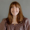 Claire Ristow wearing a brown boho shirt in front of a gray background.