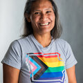 Nikki wearing gray t-shirt with Iowa logo with rainbow striping