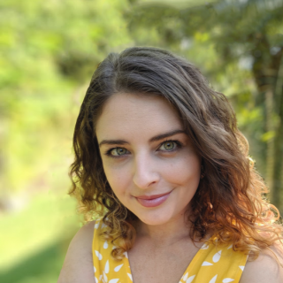 Helena McCabe with curly brown hair and green eyes