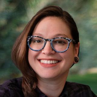 headshot of Marissa Epstein, a smiling woman wearing a collared shirt and glasses